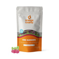 Orange County CBD Gummies packaging with a cherry flavor gummy on a white background