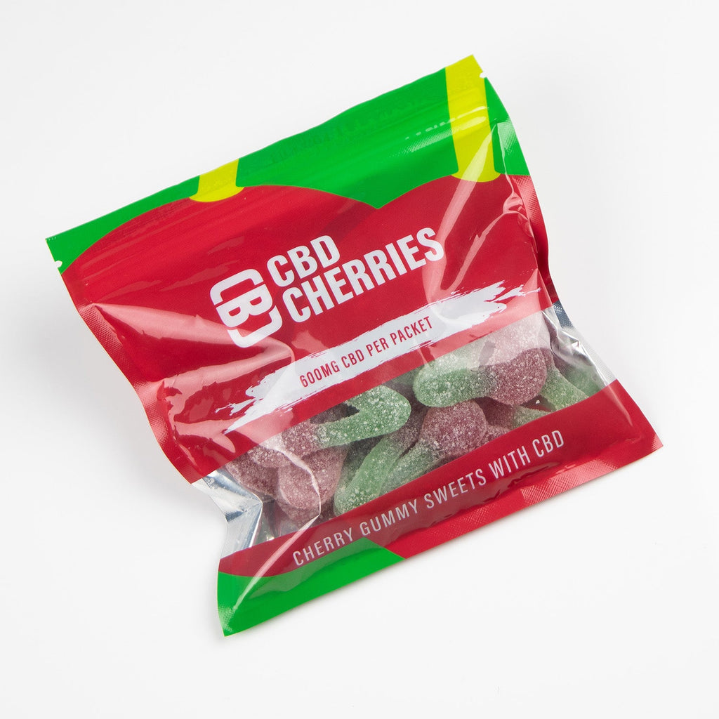 Packaged CBD gummy cherries with red and green design on a white background