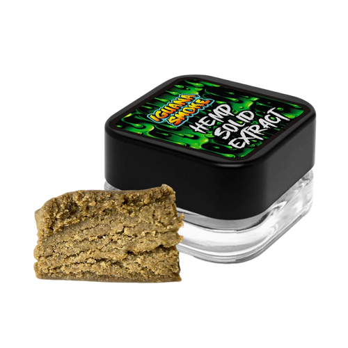 Jar of cannabis extract with a piece of cannabis on a white background