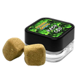 Black container with green label featuring 'Hash CBD' and two beige固体块状物 on a white background