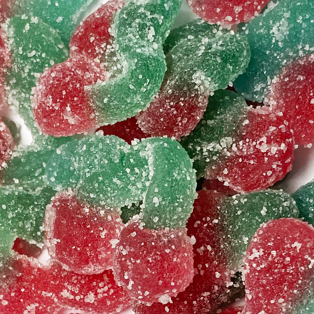 Close-up of red and green gummy worms with a sugary coating.