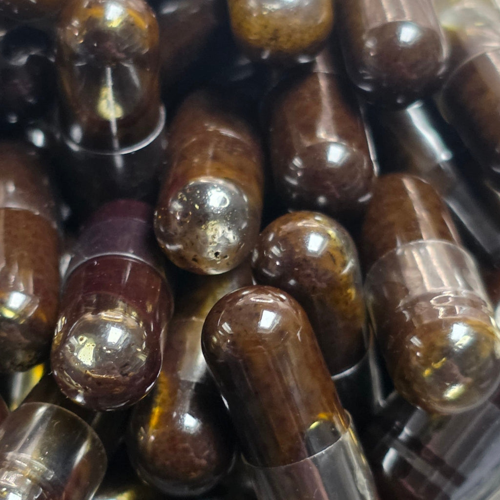 Close-up of brown glass bottles with metallic caps.