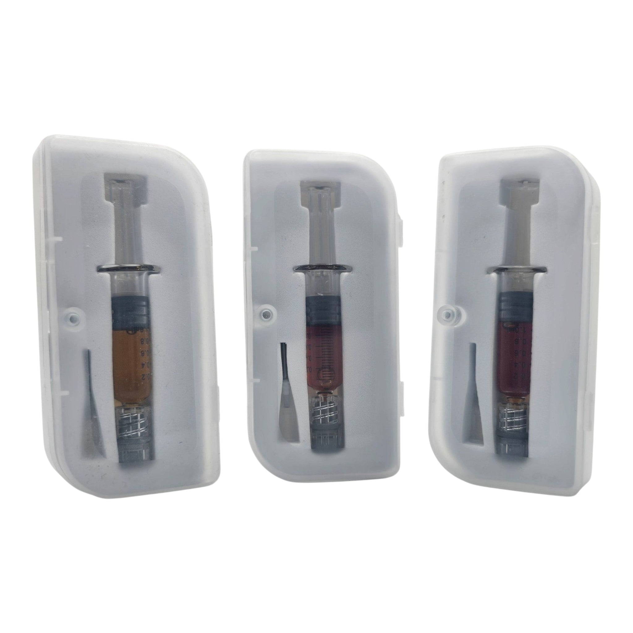 Three dental syringes in clear plastic cases on a white background