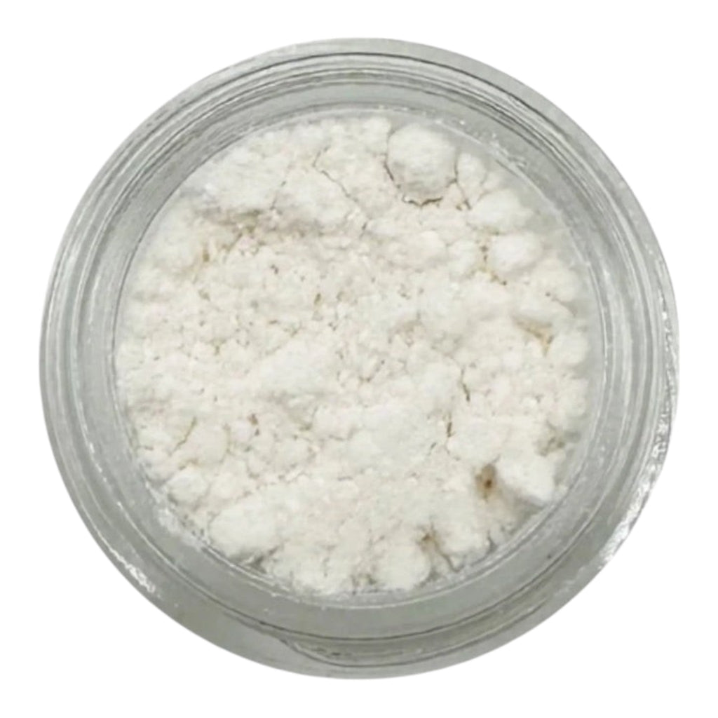 Clear container filled with white cosmetic powder on a white background