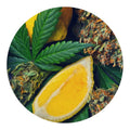 Cannabis leaves and buds with a lemon wedge on a white background