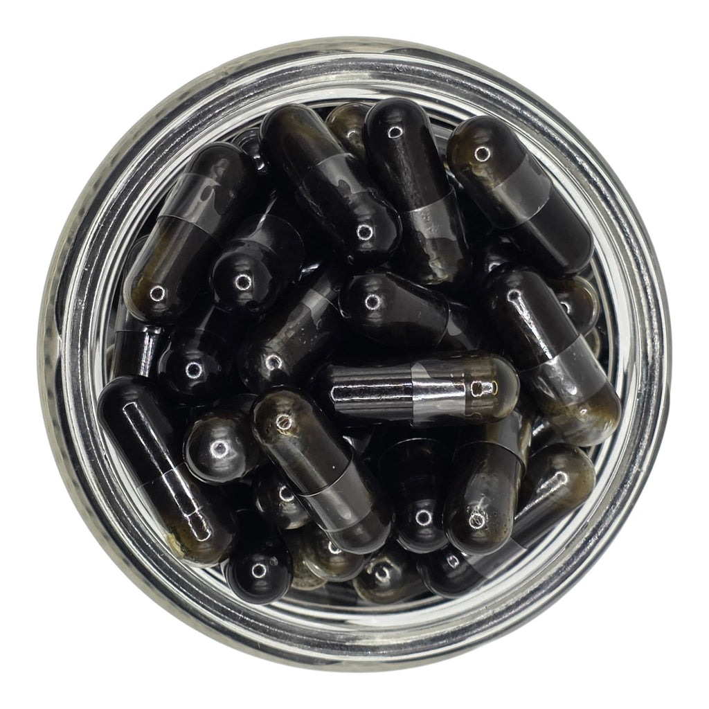 Clear jar filled with black and transparent bullet-shaped objects on a white background