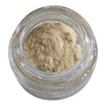 Clear glass jar filled with beige powder on a white background