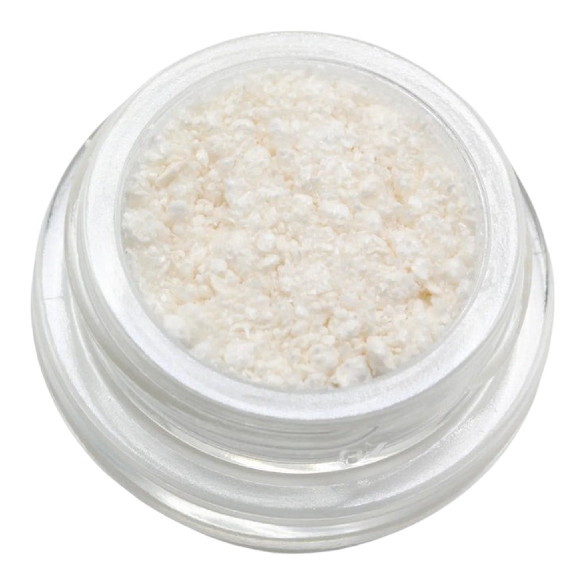 Small clear container filled with white granular substance on a white background