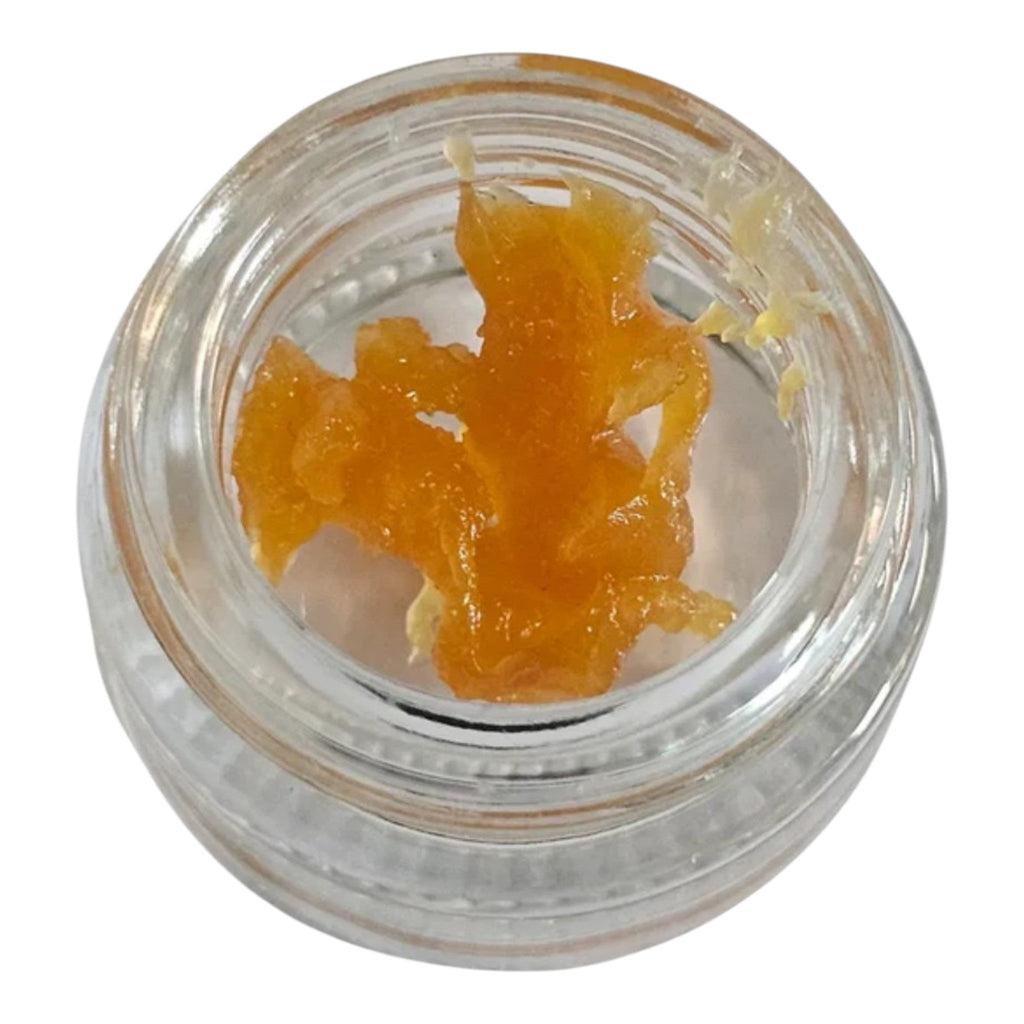 Clear container with orange substance on a white background