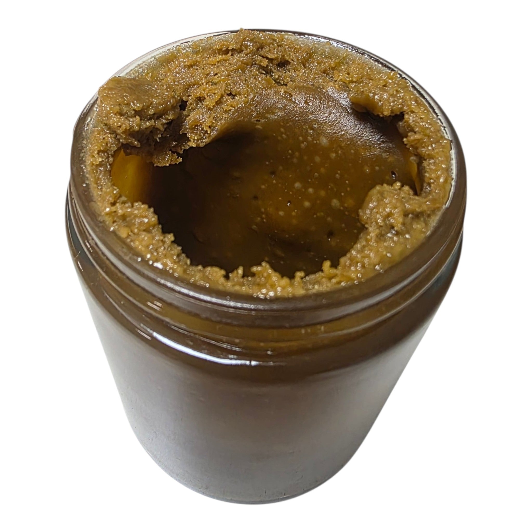 Jar of brown paste with a white background